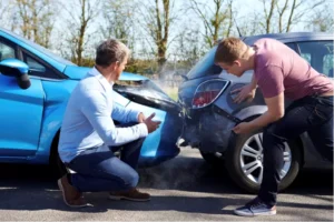 Insurance adjusters inspecting a damaged vehicle after an accident